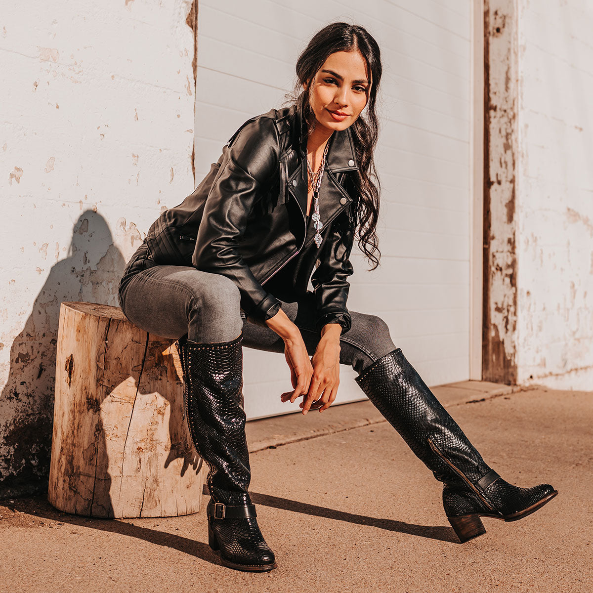 FREEBIRD women's Carson black snake tall boot with metal zipper, stud detailing and ankle strap lifestyle image