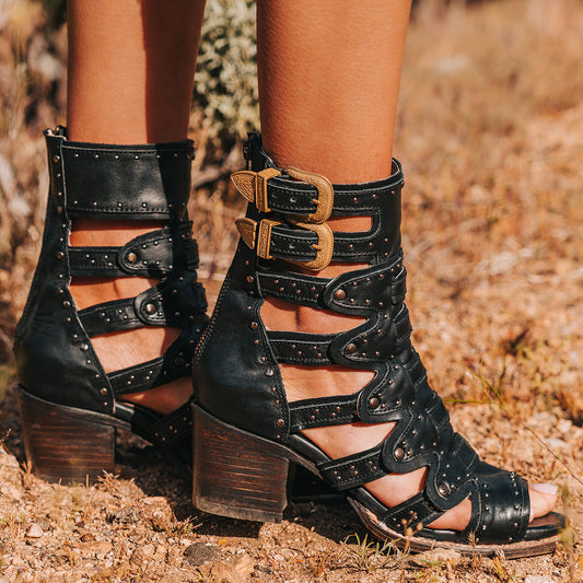 FREEBIRD women's Cashmere black leather sandal with gold adjustable shaft straps, a structured double layer leather detailing and stud embellishments