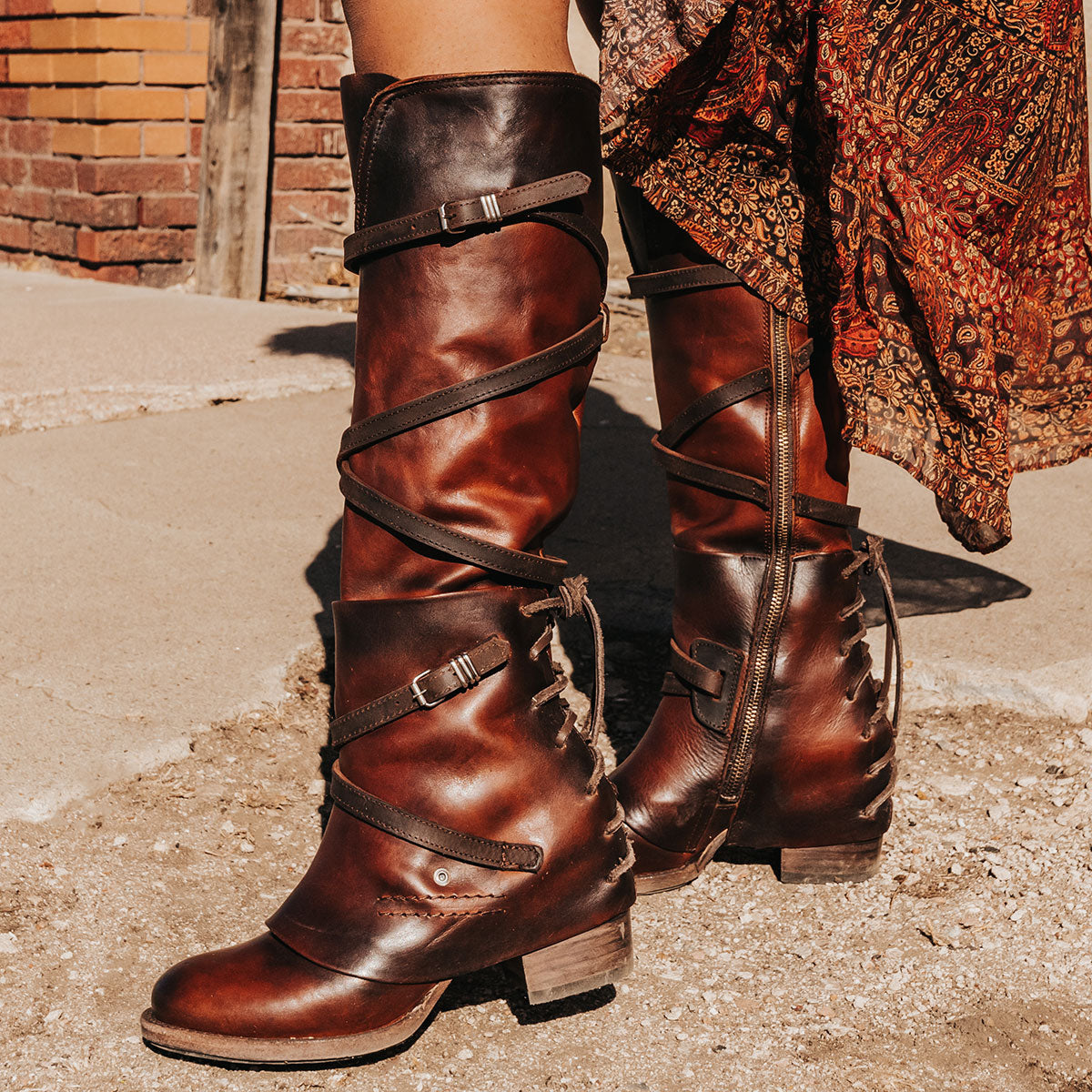 FREEBIRD women's Cassius brown distressed strappy tall boot with back lacing ankle overlay