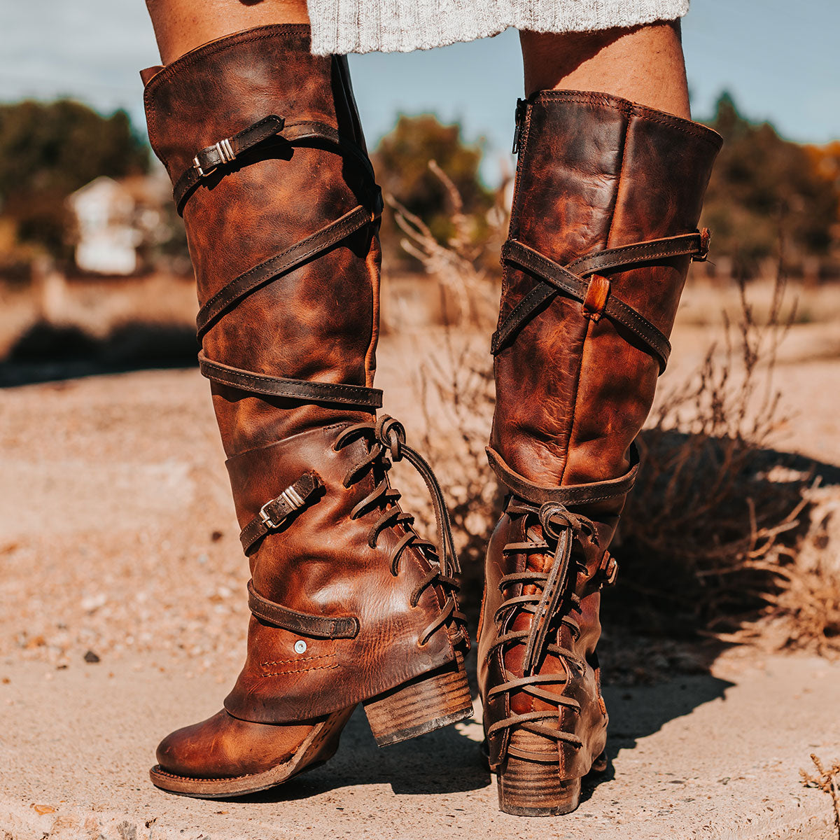 FREEBIRD women's Cassius brown distressed strappy tall boot with back lacing ankle overlay