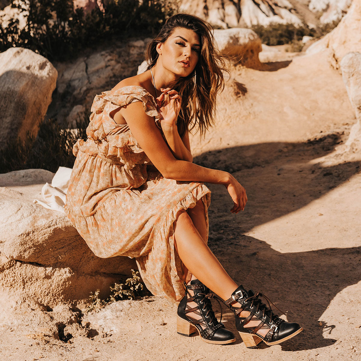  FREEBIRD women's Cheyenne black multi laser cut criss-cross leather lace up front silver buckle detail ankle bootie lifestyle image