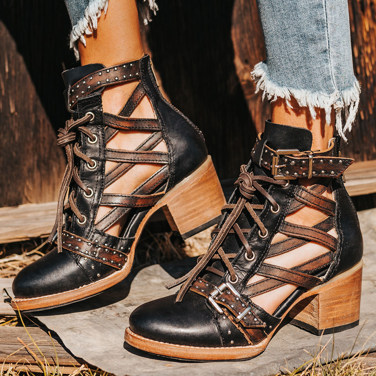 FREEBIRD women's Cheyenne black multi laser cut criss-cross leather lace up front silver buckle detail ankle bootie