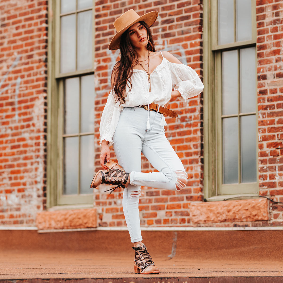 FREEBIRD women's Cheyenne taupe multi laser cut criss-cross leather lace up front silver buckle detail ankle bootie lifestyle image