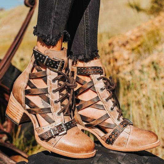 FREEBIRD women's Cheyenne taupe multi laser cut criss-cross leather lace up front silver buckle detail ankle bootie