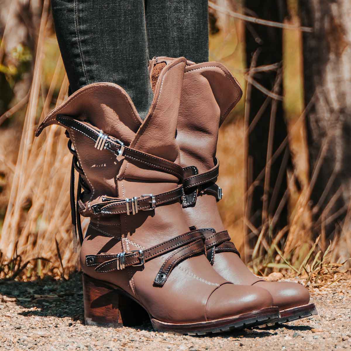 Clay CORA leather booties featuring a back-lacing design, slouchy silhouette, and adjustable silver buckle straps