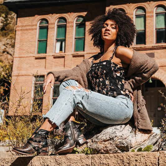 FREEBIRD women's Crue black distressed leather cutout ankle bootie with silver hardware straps and back lacing detail lifestyle image