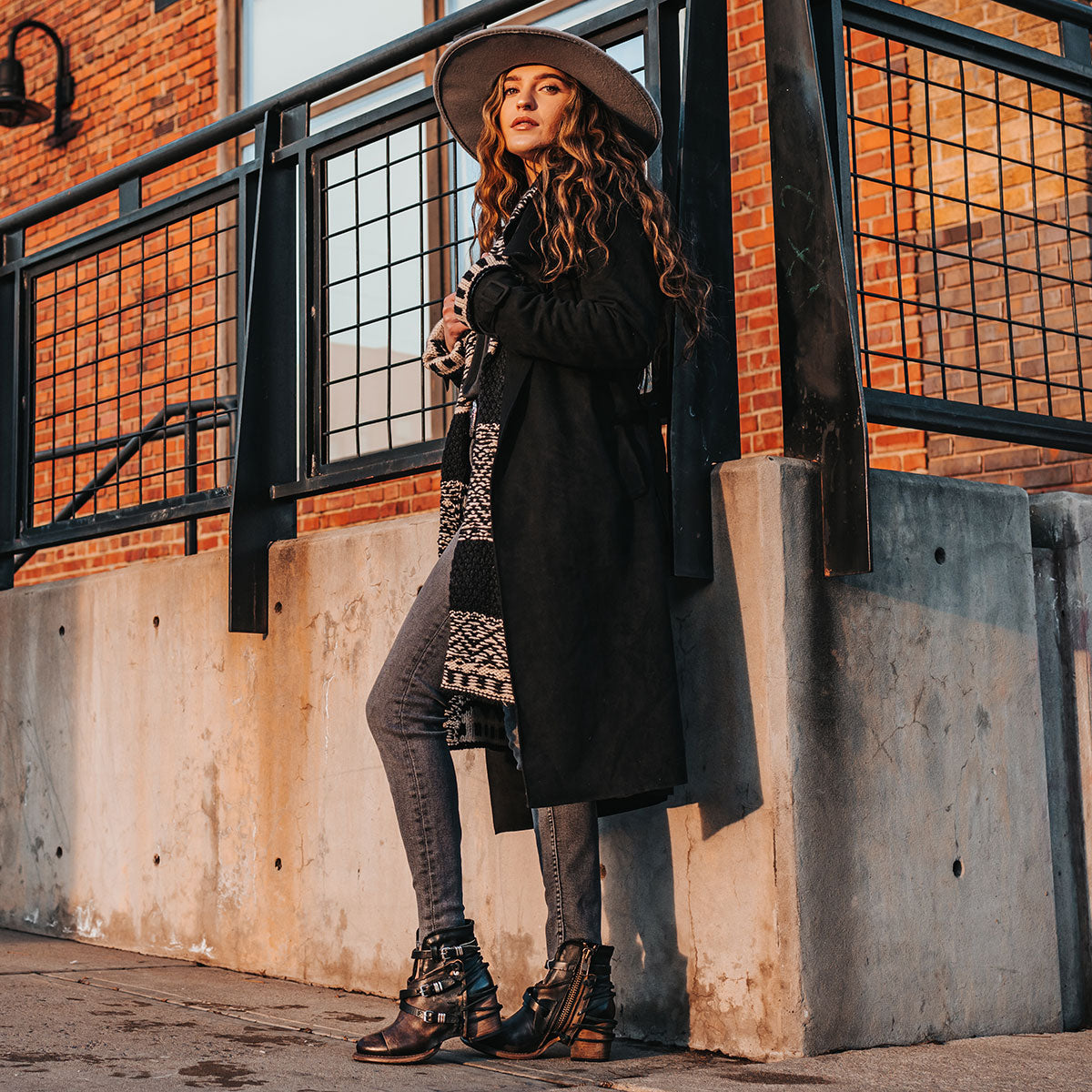  FREEBIRD women's Crue black distressed leather cutout ankle bootie with silver hardware straps and back lacing detail lifestyle image