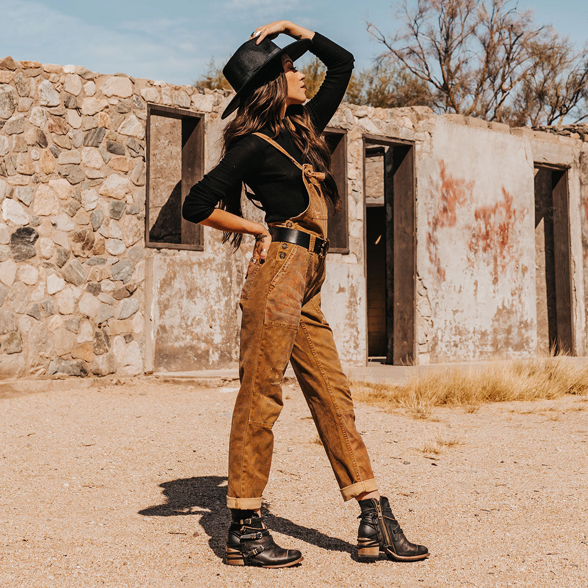 FREEBIRD women's Crue black distressed leather cutout ankle bootie with silver hardware straps and back lacing detail lifestyle image