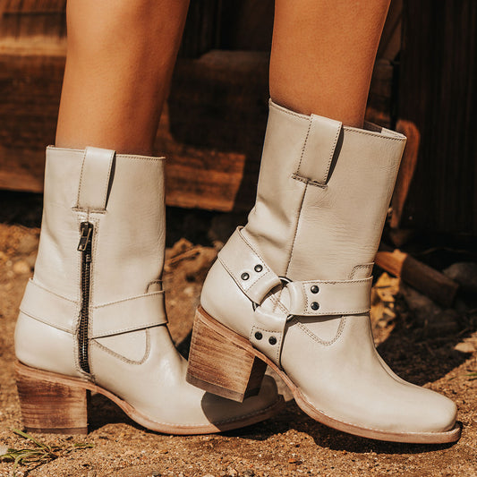 FREEBIRD women's Darcy beige leather boot with a studded ankle harness, leather pull straps, an inside zip closure and a square toe