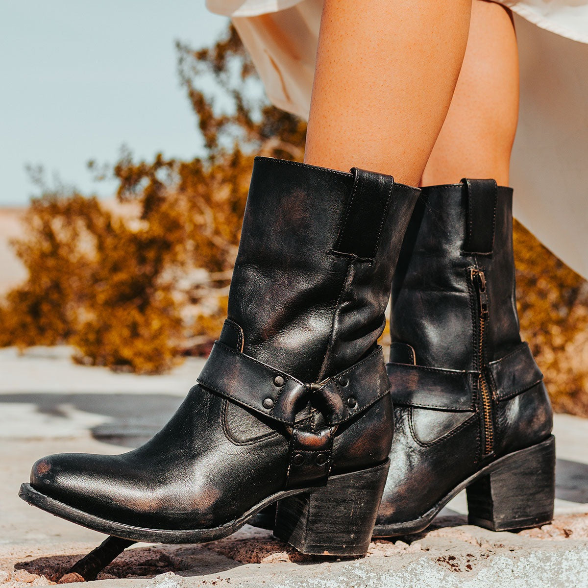 FREEBIRD women's Darcy black leather boot with a studded ankle harness, leather pull straps, an inside zip closure and a square toe