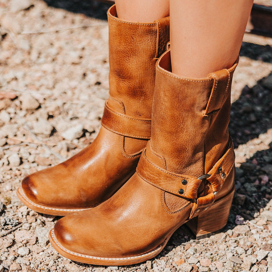 FREEBIRD women's Darcy wheat leather boot with a studded ankle harness, leather pull straps, an inside zip closure and a square toe