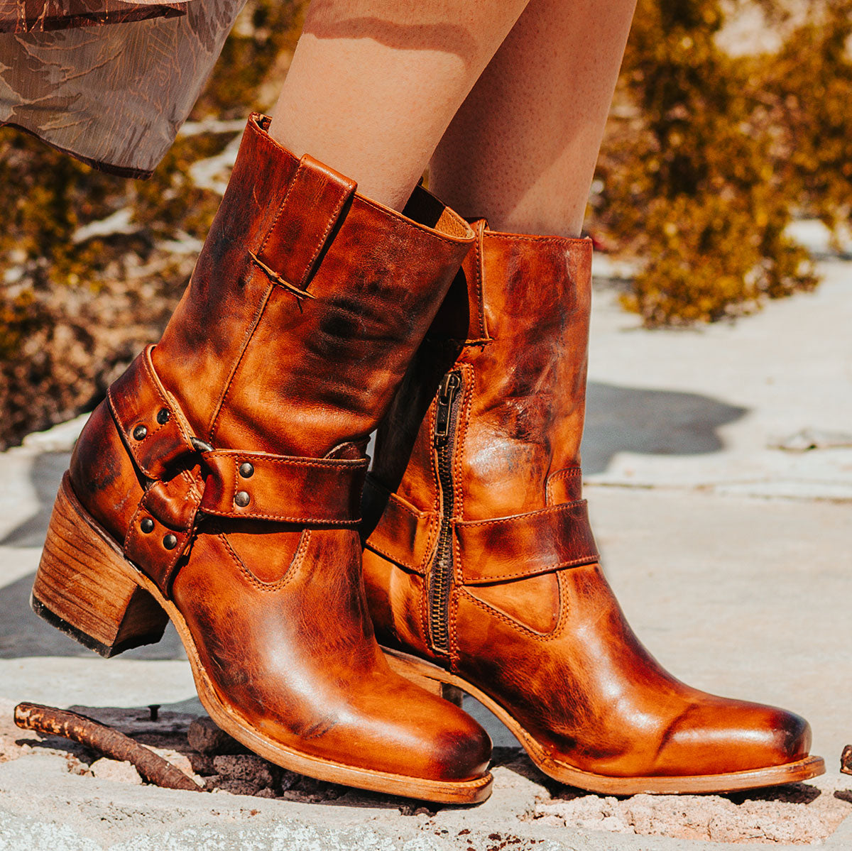 FREEBIRD women's Darcy whiskey leather boot with a studded ankle harness, leather pull straps, an inside zip closure and a square toe
