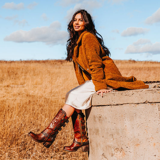 FREEBIRD women's Derby cognac leather boot with shaft buckle straps, eyelet studs and square toe construction lifestyle