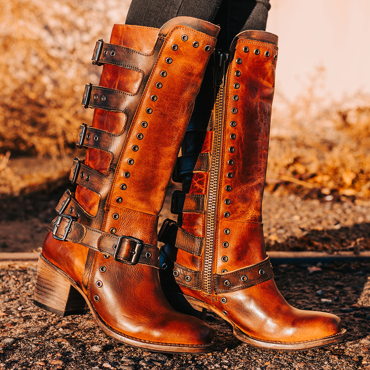 FREEBIRD women's Derby cognac leather boot with shaft buckle straps, eyelet studs and square toe construction 