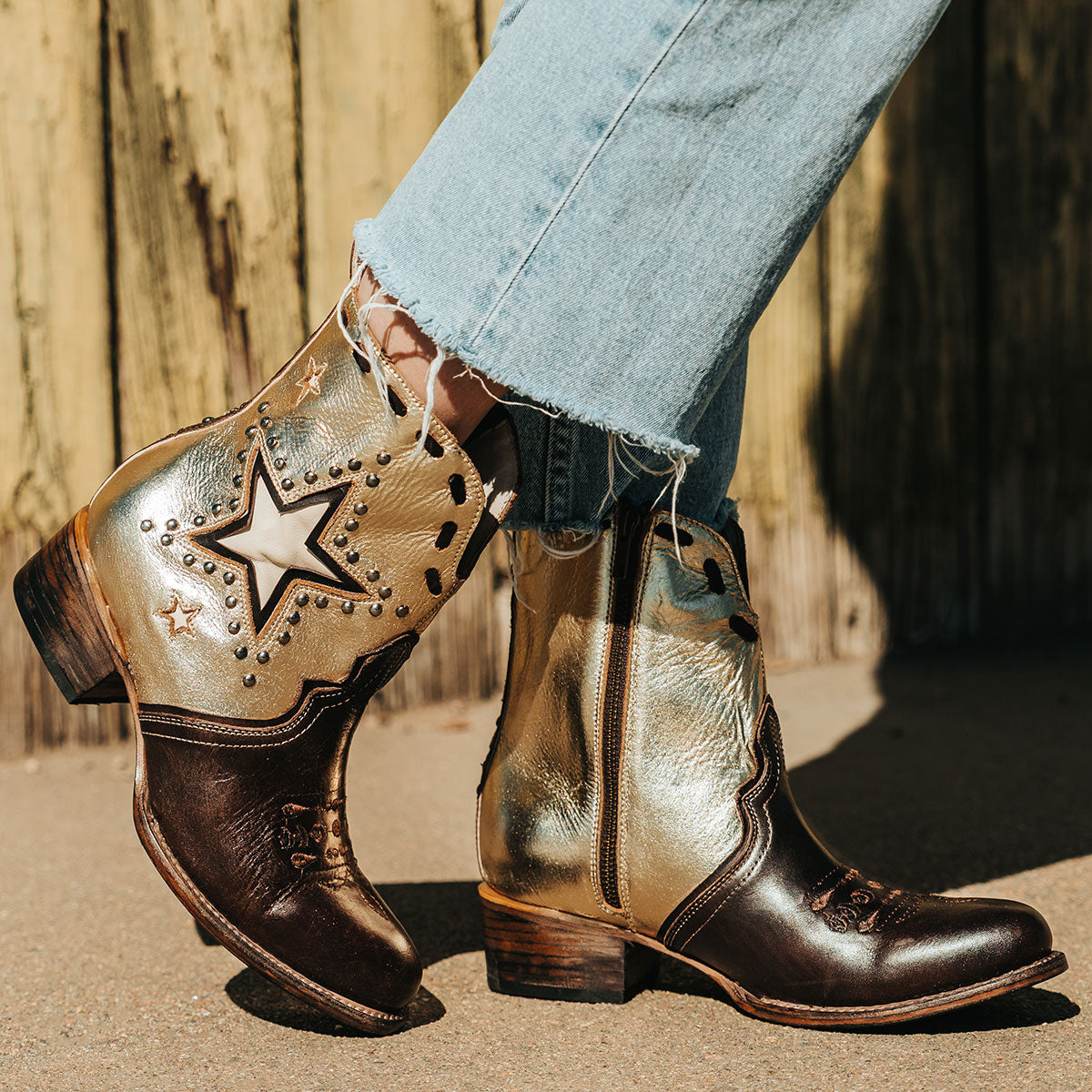 FREEBIRD women's Dolly gold/brown multi star overlay bootie with silver stud detailing, contrasting whipstitching, almond toe, and inside zip closure