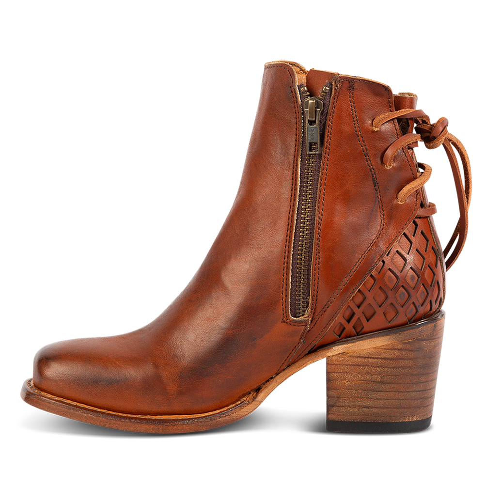 Inside view showing working brass zipper, laser cut detailing, and a stacked heel on FREEBIRD women's Dreamer whiskey leather bootie