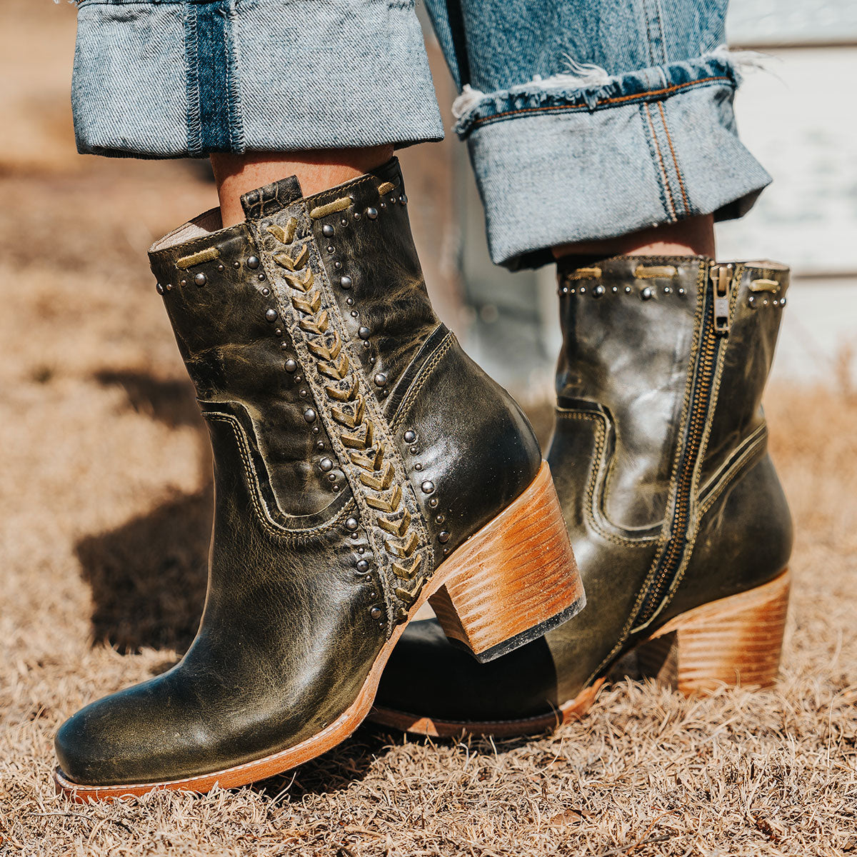 Green leather DUKE square toe booties with silver stud detailing, exterior shaft braiding, and leather stitching.