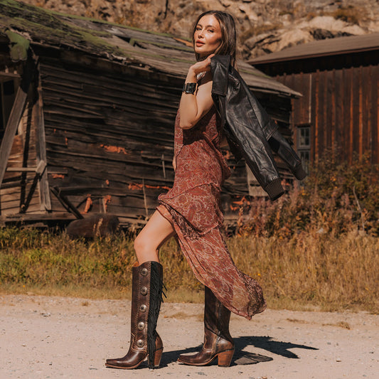Freebird women's FARRAH brown leather knee-high boot with fringe detail, concho hardware and a tall heel lifestyle