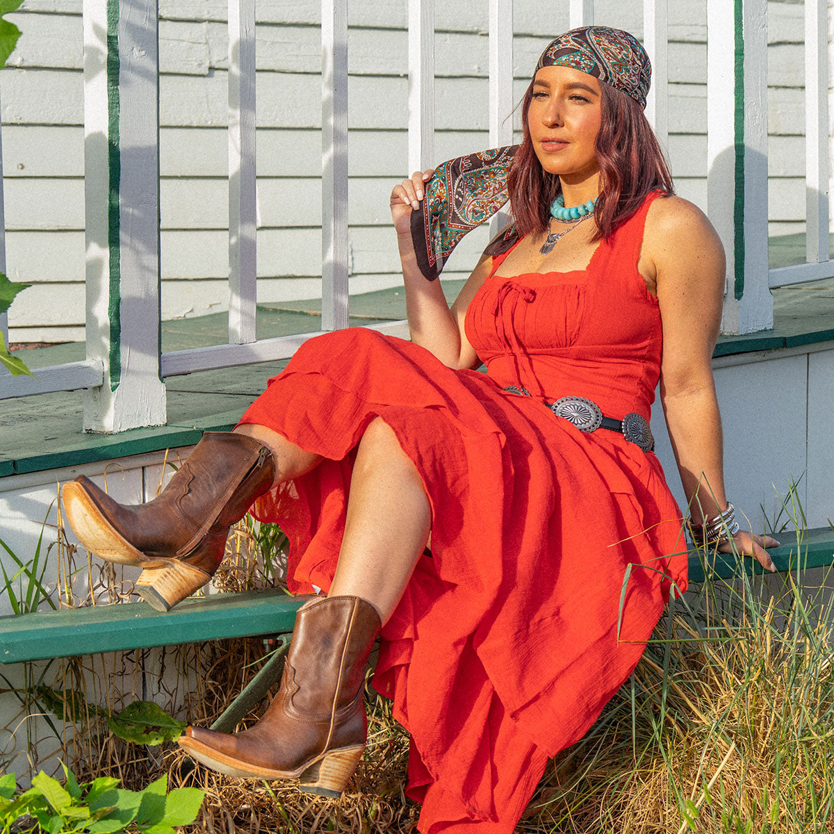 Firebird brown leather ankle booties styled with a flowing red dress