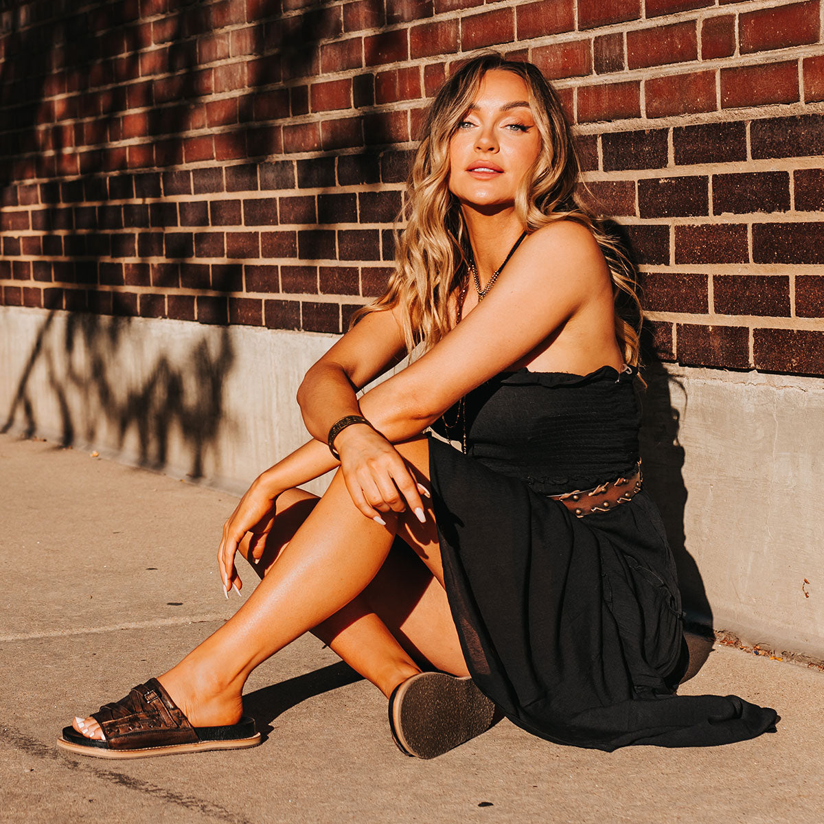 FREEBIRD women's Fleetwood black flat slip-on sandal featuring leather stitch detailing with metal buckle lifestyle