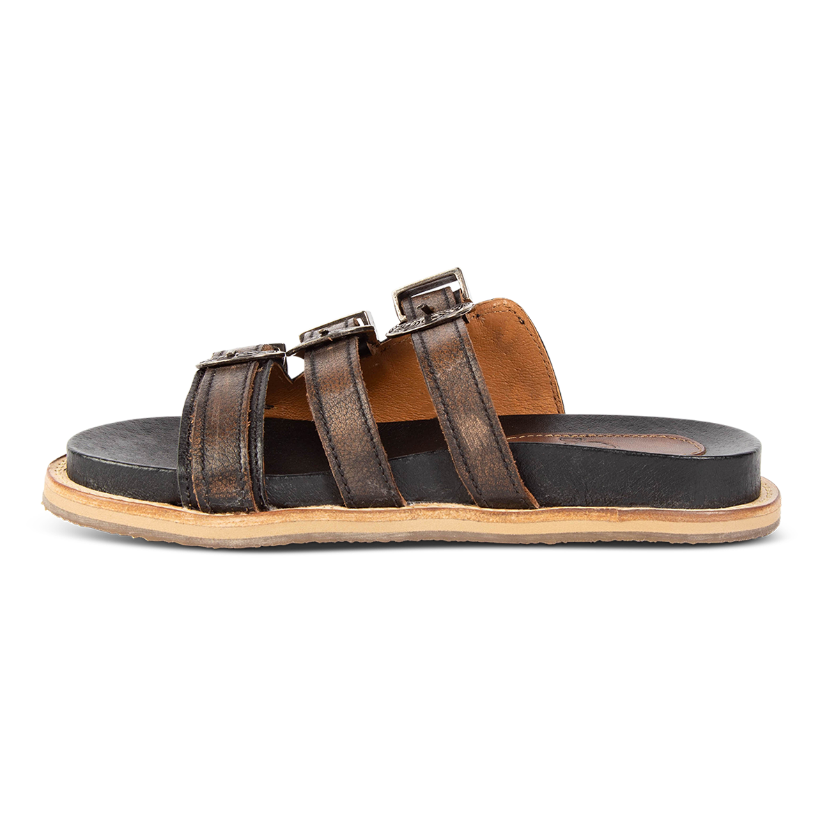 Side view showing adjustable buckles on FREEBIRD women's Franki black slip-on flat shoe featuring engraved metal detailing