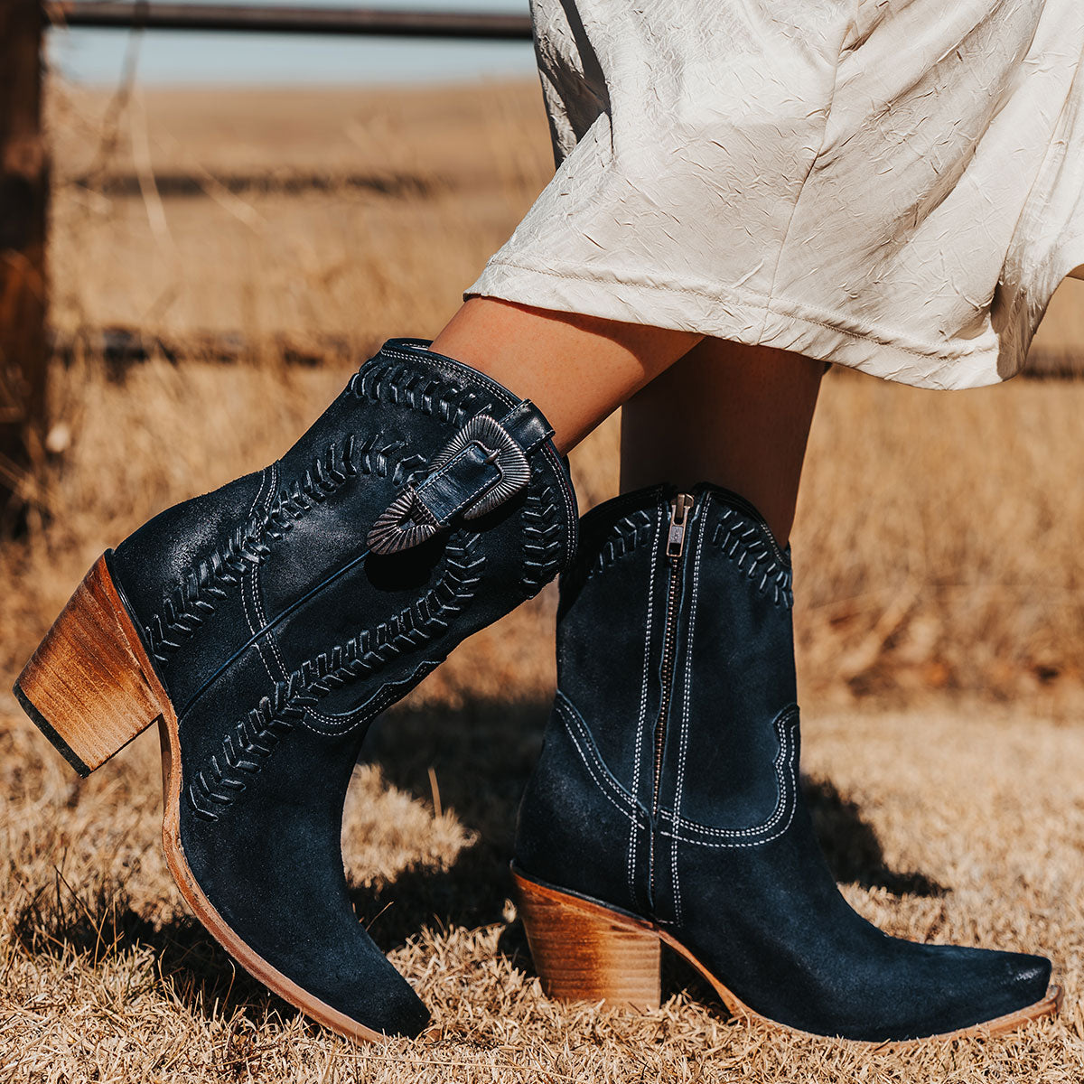 FREEBIRD women's Freya blue suede bootie with whip stitch detailing, a snip toe silhouette and decorative vintage buckle. Finished with an inside working zipper.
