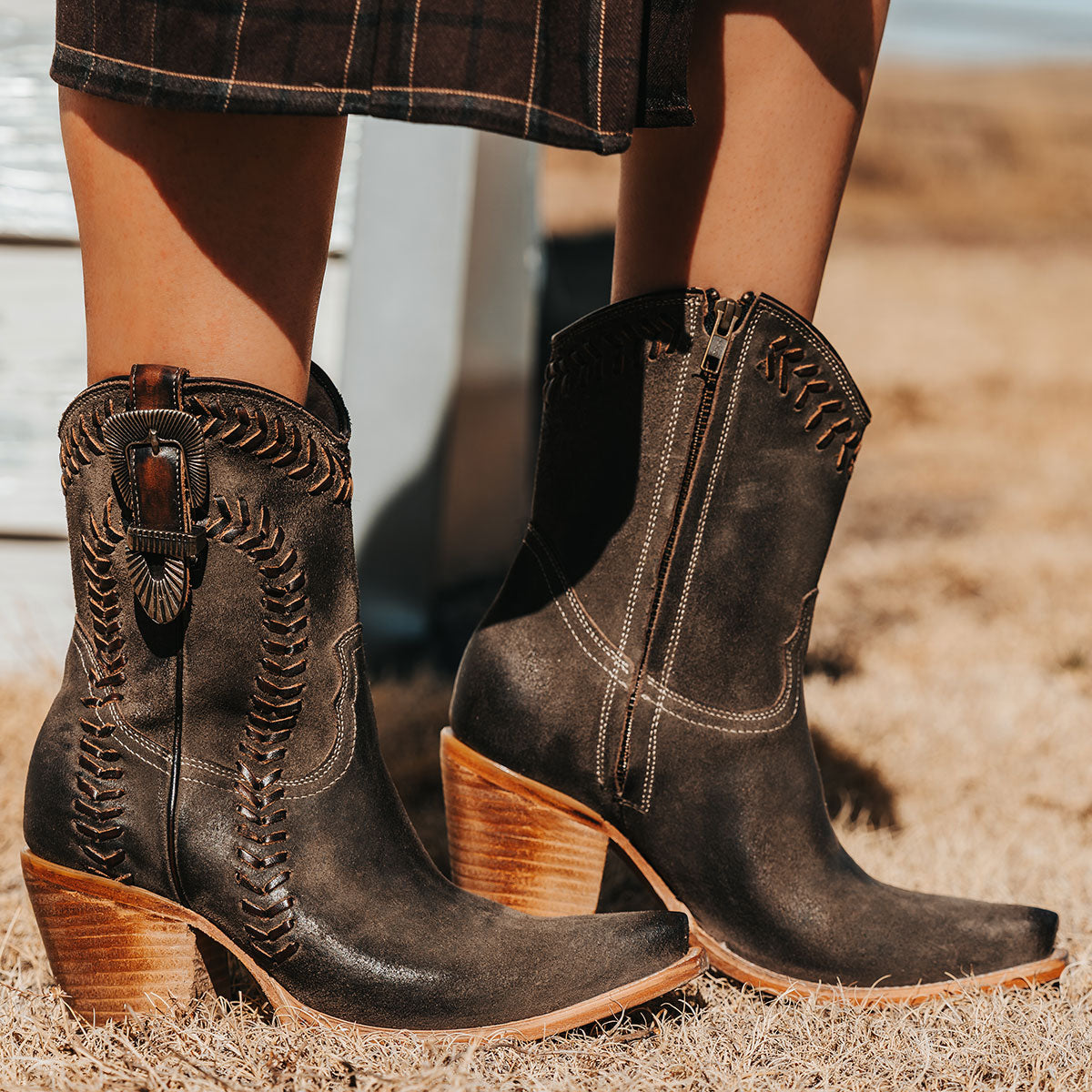 FREEBIRD women's Freya grey suede bootie with whip stitch detailing, a snip toe silhouette and decorative vintage buckle. Finished with an inside working zipper.