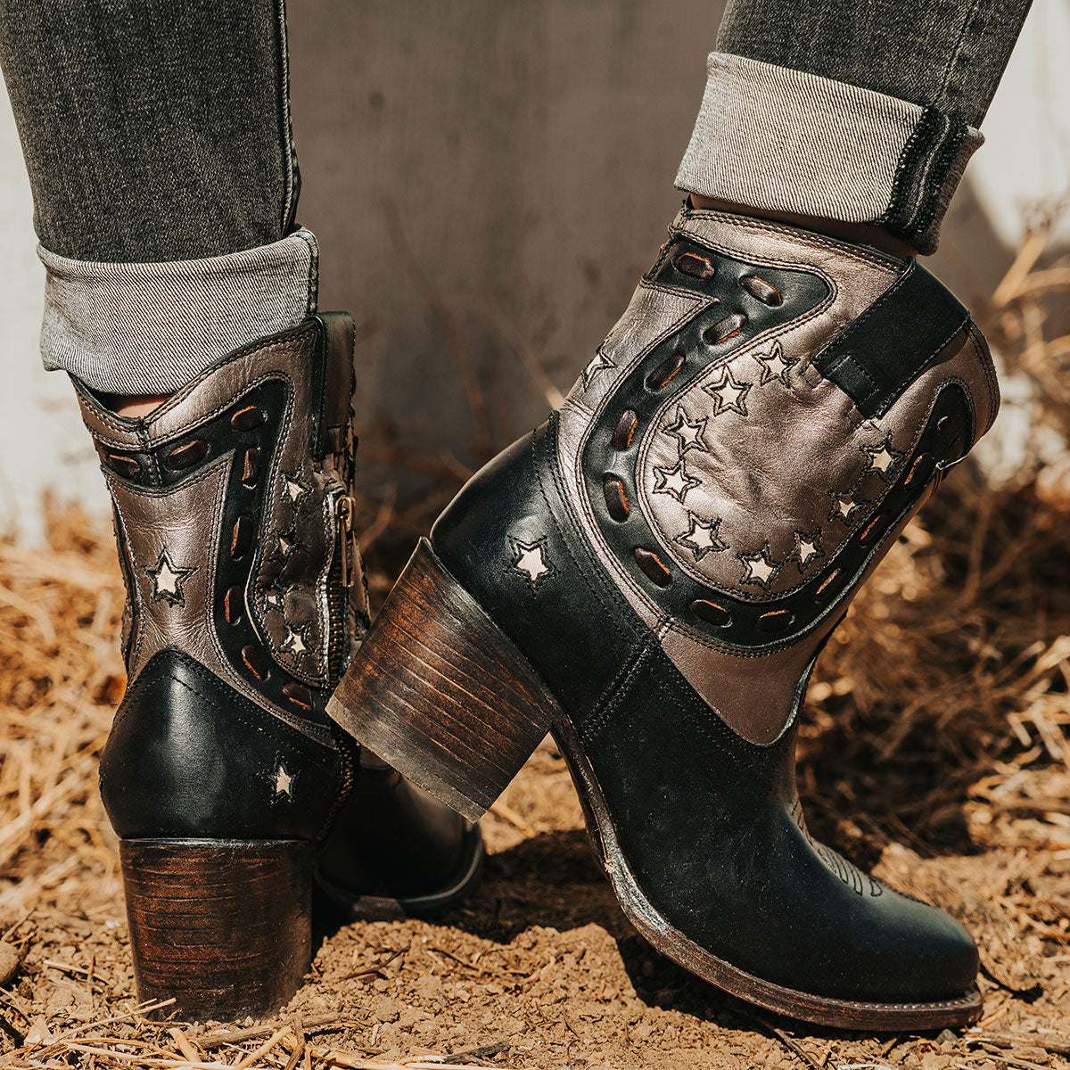 Black GAMBLER leather booties with western-style horseshoe overlays, silver-tone buckles, and a stacked block heel.