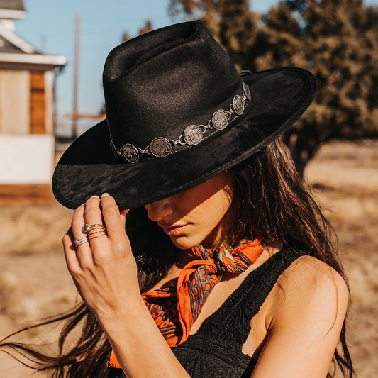 FREEBIRD Gemini black wide flat-brim hat featuring diamond-shaped crown and metal coin band lifestyle