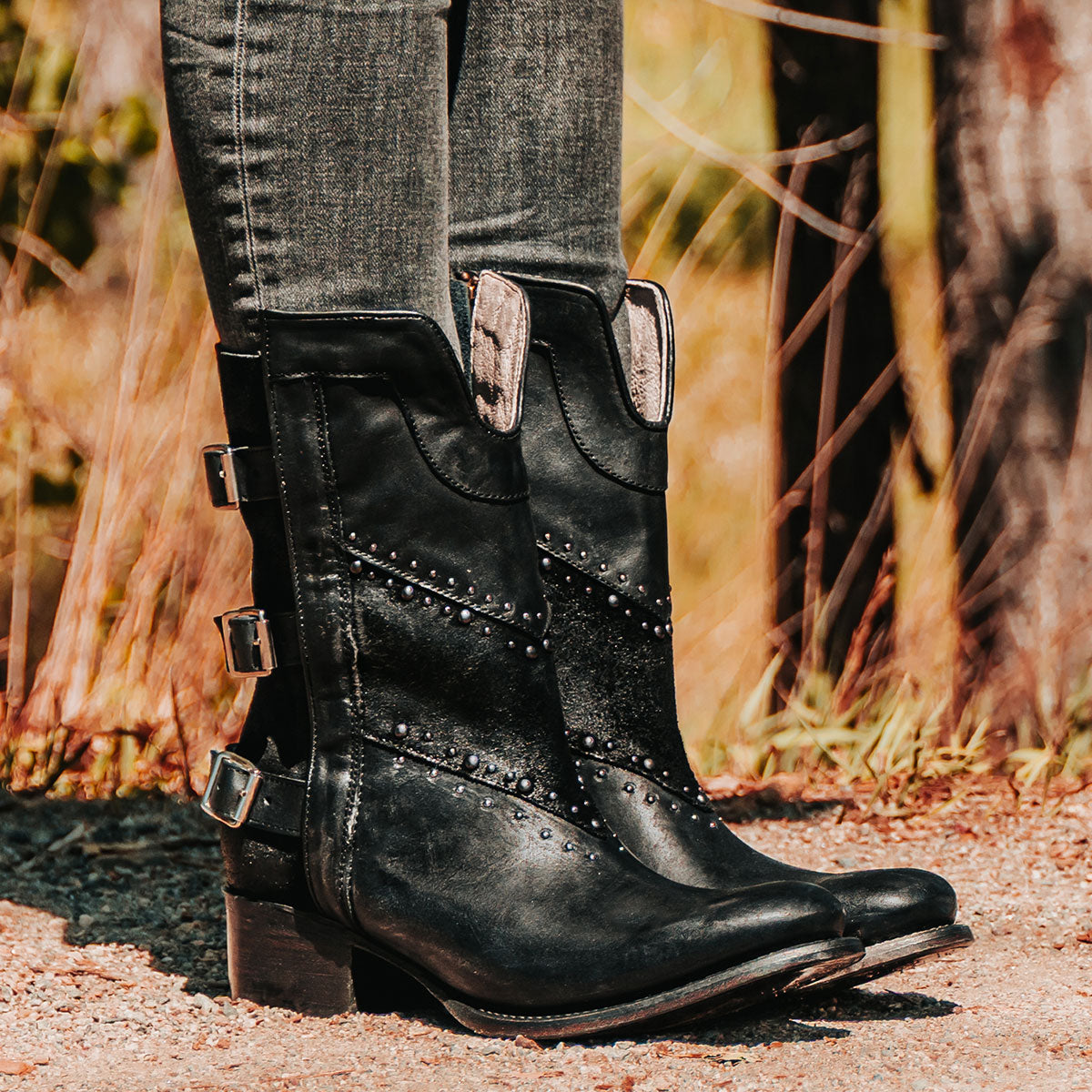 Freebird women's GOLDIE black suede and leather boot with stud embellishments, front shin cut out and adjustable buckle straps around the calf