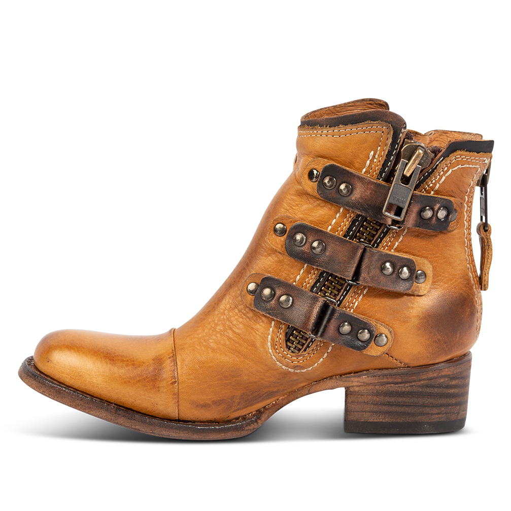 Inside view showing studded straps and low block heel on FREEBIRD women's Grecko cognac leather ankle bootie