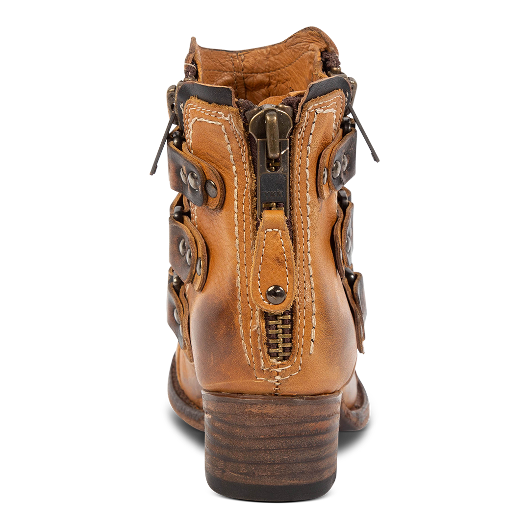 Back view showing block heel and heel brass zip closure on Freebird women's Grecko cognac leather ankle bootie
