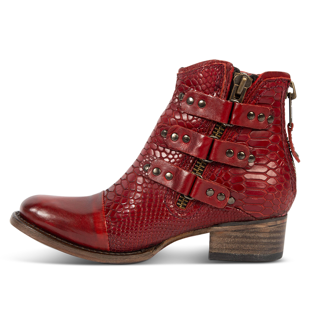Inside view showing studded straps and low block heel on FREEBIRD women's Grecko red leather ankle bootie