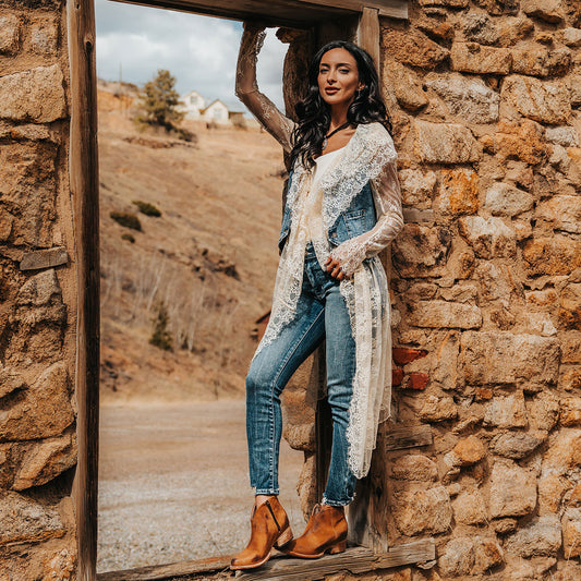 FREEBIRD women's Hippy cognac suede low heeled bootie with a working brass zip closure, heel seam embroidery, almond toe, and front dip detailing lifestyle