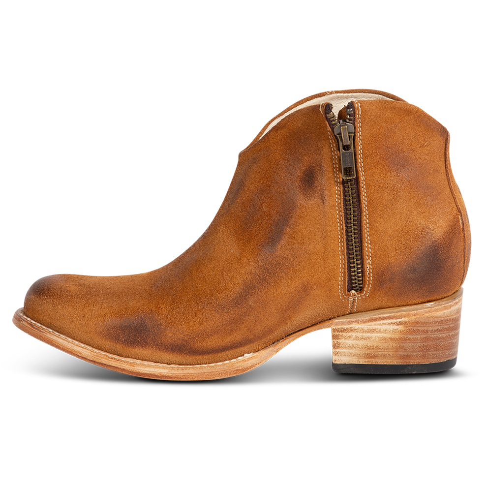 Inside view showing low leather wrapped heel and working brass zip closure on FREEBIRD women's Hippy cognac suede bootie
