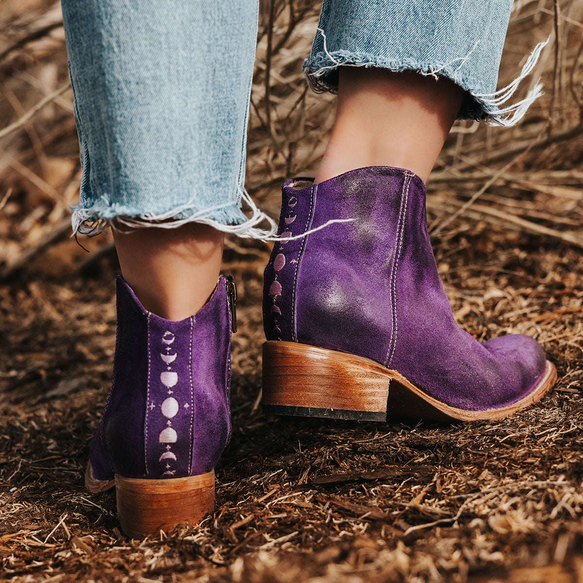 FREEBIRD women's Hippy purple suede low heeled bootie with a working brass zip closure, heel seam embroidery, almond toe, and front dip detailing