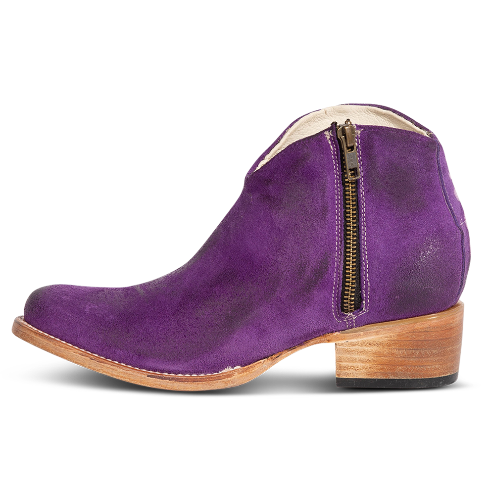 Inside view showing low leather wrapped heel and working brass zip closure on FREEBIRD women's Hippy purple suede bootie