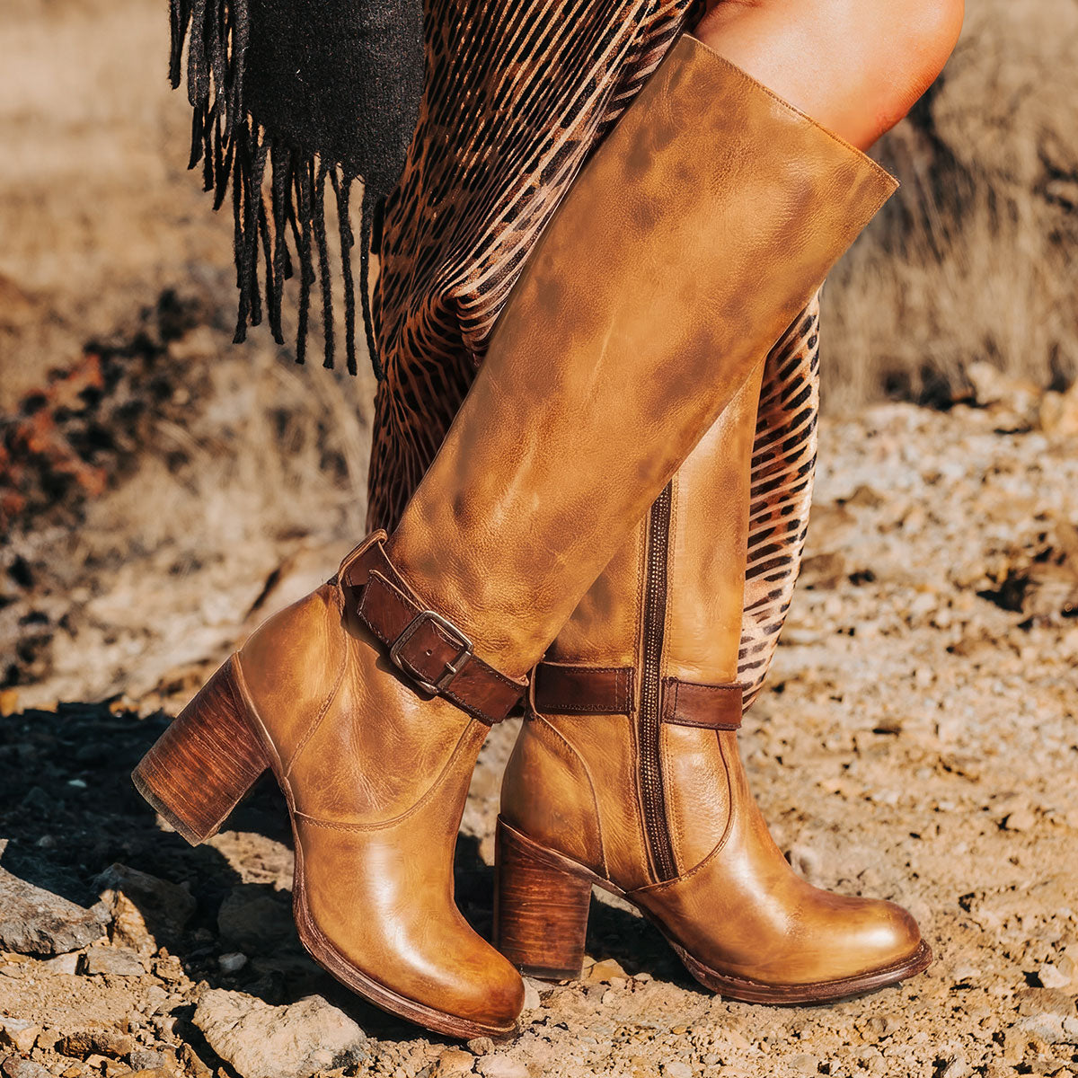 Freebird women's HOLLAND honey leather tall boot with a full inside brass zipper, in-step adjustable belt and bold high heel