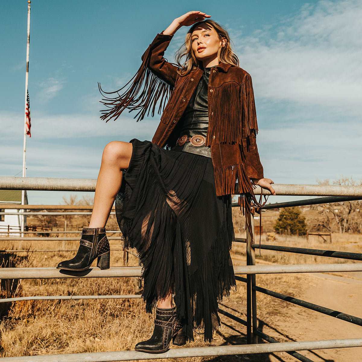 FREEBIRD women's Jovi black suede bootie with inside zip closure, flare heel, and stud detailing lifestyle image