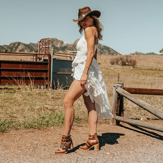 FREEBIRD women's Judge tan leather bootie with engraved belts, contrating metal embellishments and a stacked heel lifestyle