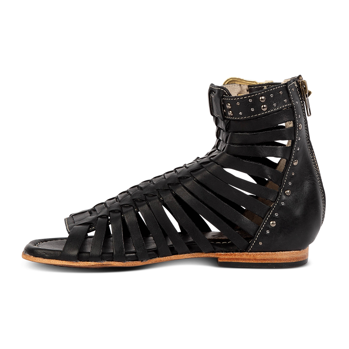 Inside view show FREEBIRD women's Luna black leather sandal with a gladiator silhouette, adjustable brass buckle and subtle stud embellishments on a low heel 