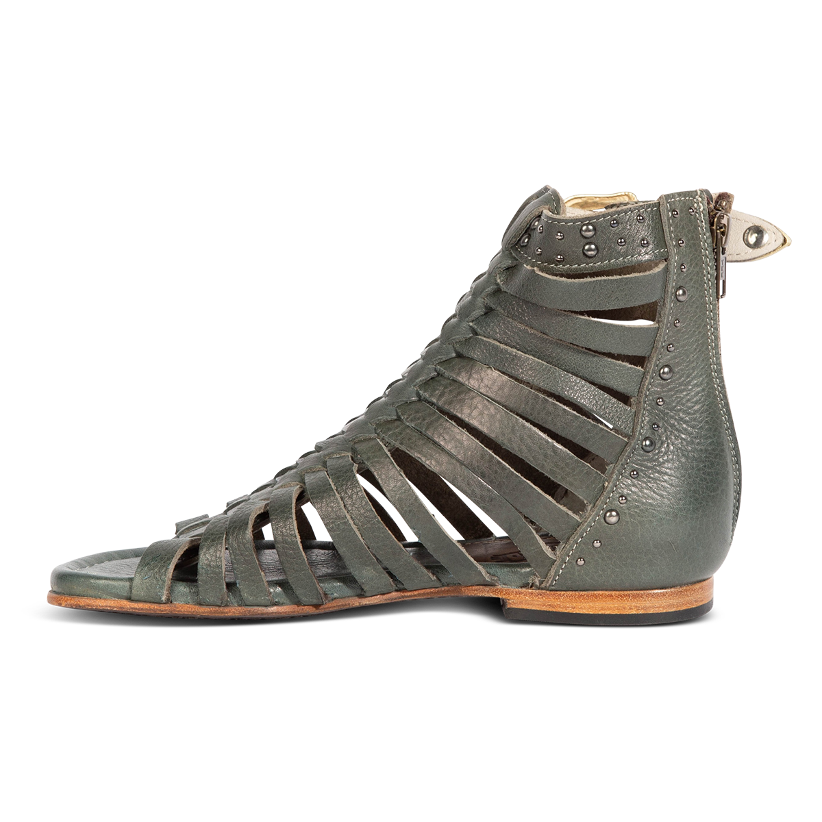 Inside view show FREEBIRD women's Luna teal leather sandal with a gladiator silhouette, adjustable brass buckle and subtle stud embellishments on a low heel 