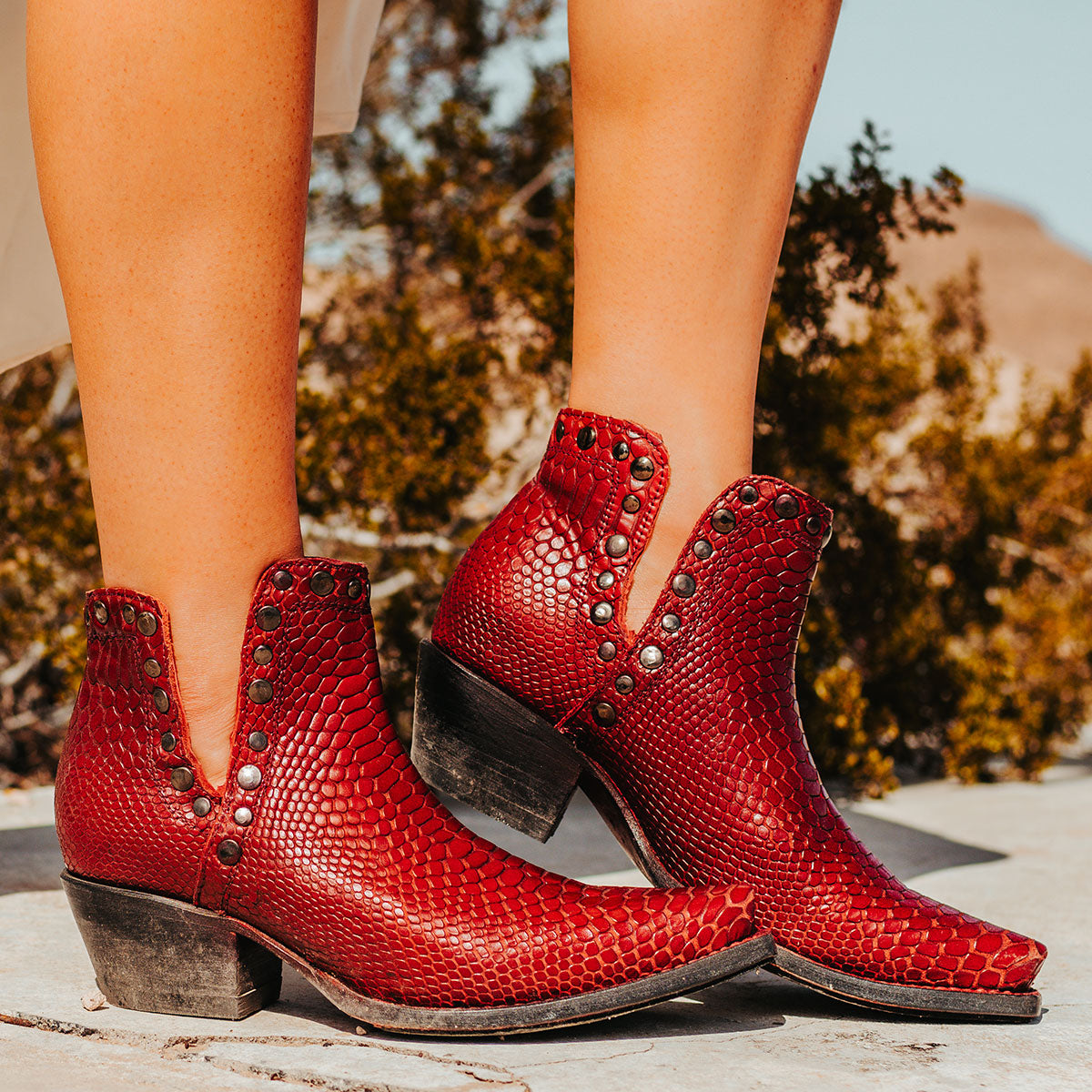 FREEBIRD women's Mandy red embossed leather ankle bootie with exposed ankle cutouts, studded detailing and snip toe construction