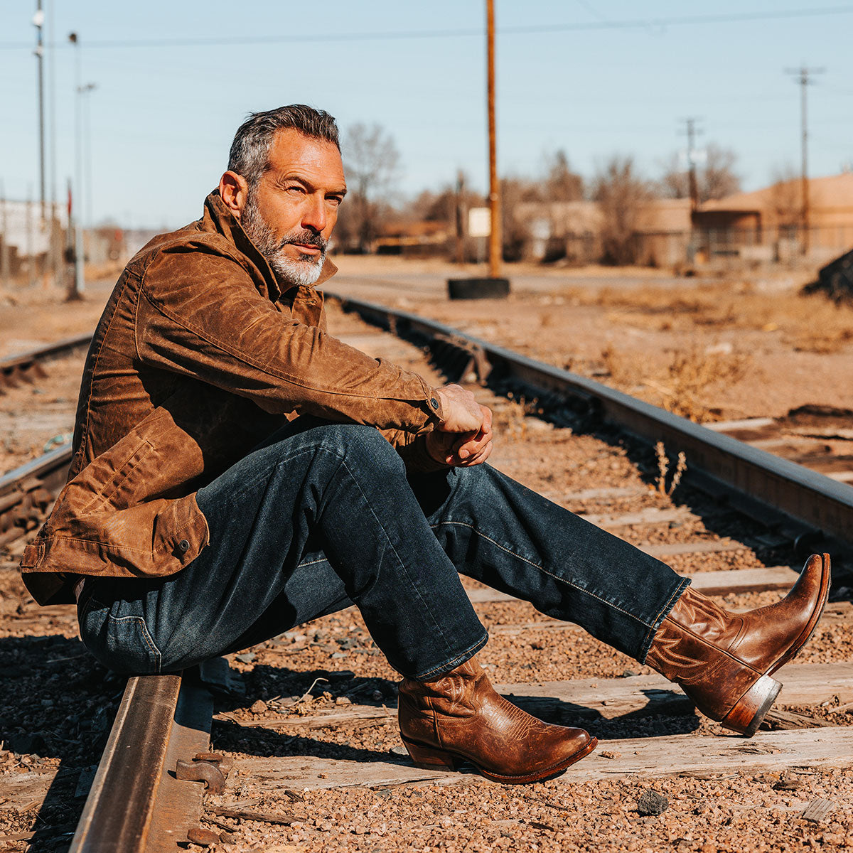 FREEBIRD men's Marshall brown leather western cowboy boot with shaft stitch detailing, snip toe construction and leather pull straps lifestyle image