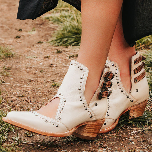 FREEBIRD women's Melody beige leather shoe with v-cut sides, stud detailing, and low heel