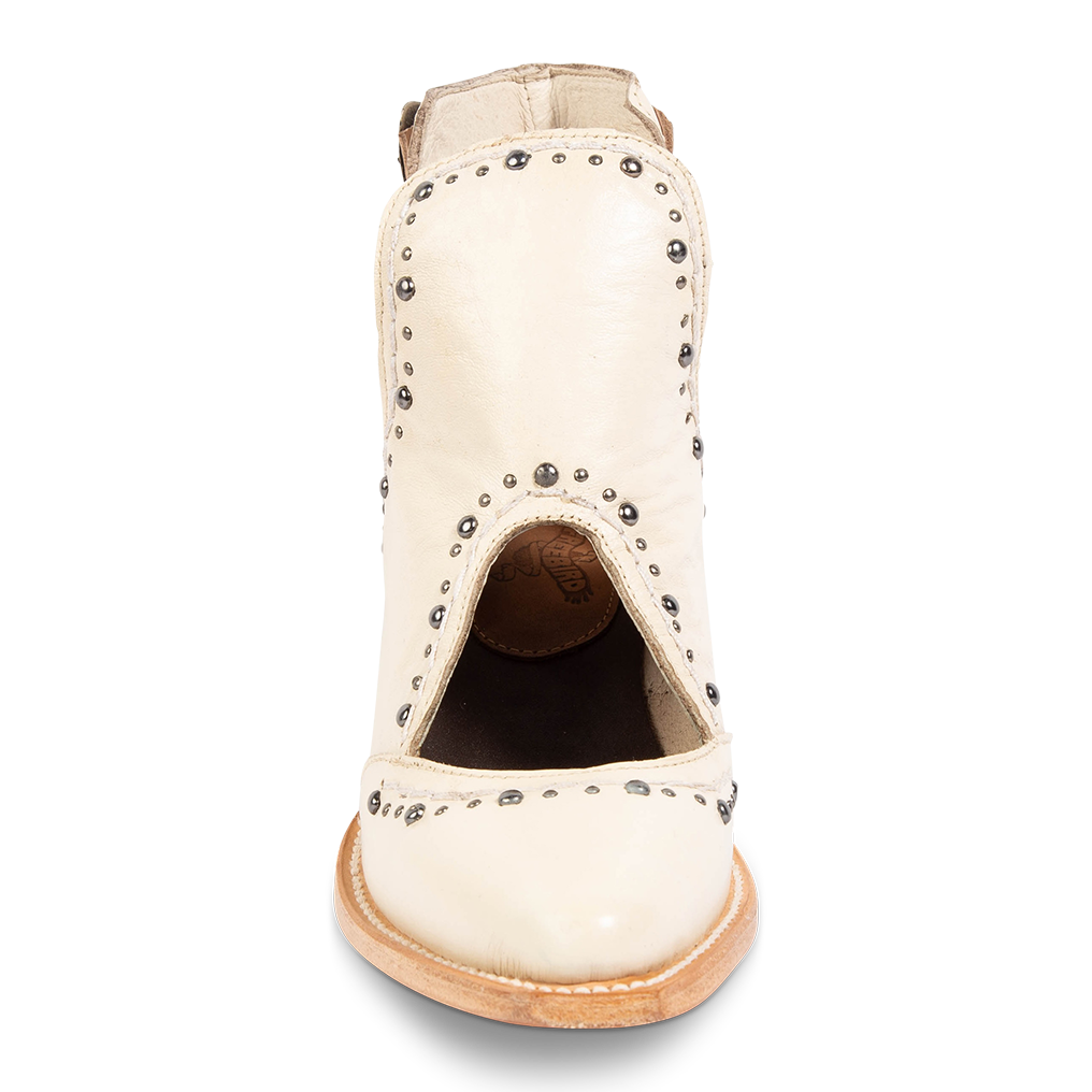 Front view showing instep cutout and silver stud trim detailing on FREEBIRD women's Melody beige leather shoe