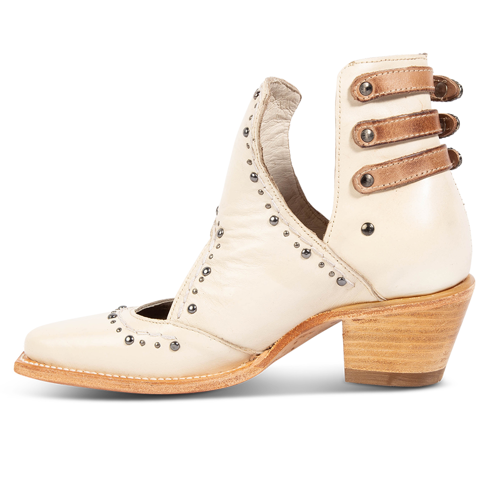 Inside view showing v-cut sides, stud trim detailing, and contrasting heel straps on FREEBIRD women's Melody beige leather shoe