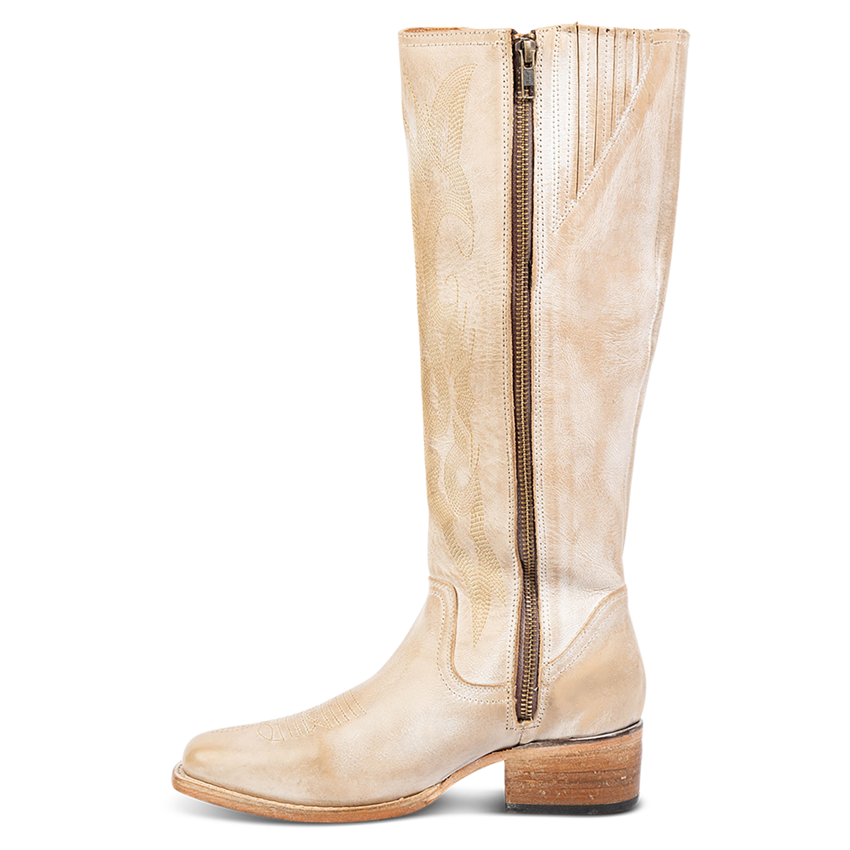Inside view showing a low block heel, inside working brass zipper, and gore detailing on FREEBIRD women's Montana beige leather boot