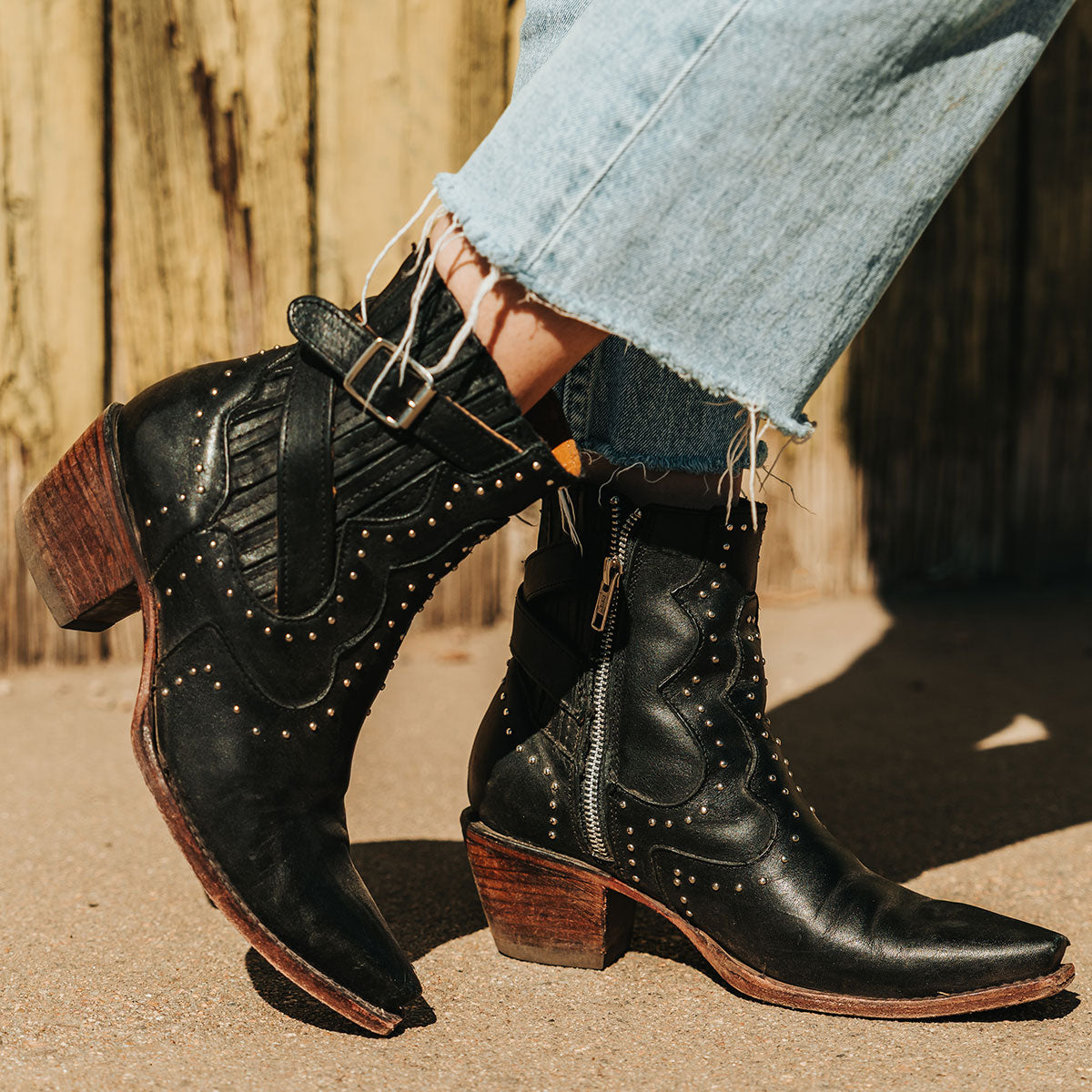 FREEBIRD women's Morgan black leather ankle bootie with silver stud embellishments, gore detailing, and buckle straps