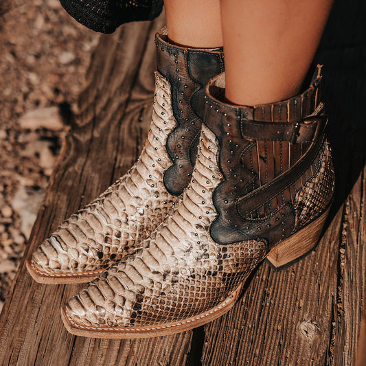 FREEBIRD women's Morgan black white python leather ankle bootie with silver stud embellishments, gore detailing, and buckle straps